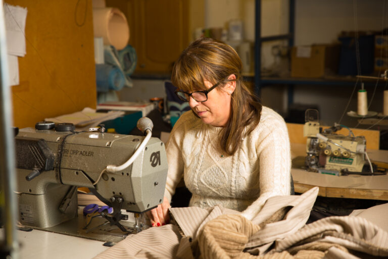 woman sewing sofa fabric