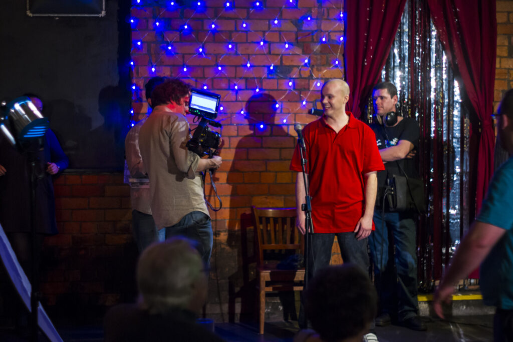 Actor on the set of final punchline with film crew