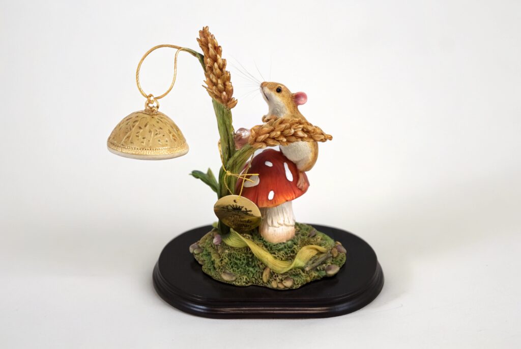 sculpture of a mouse on a toadstool