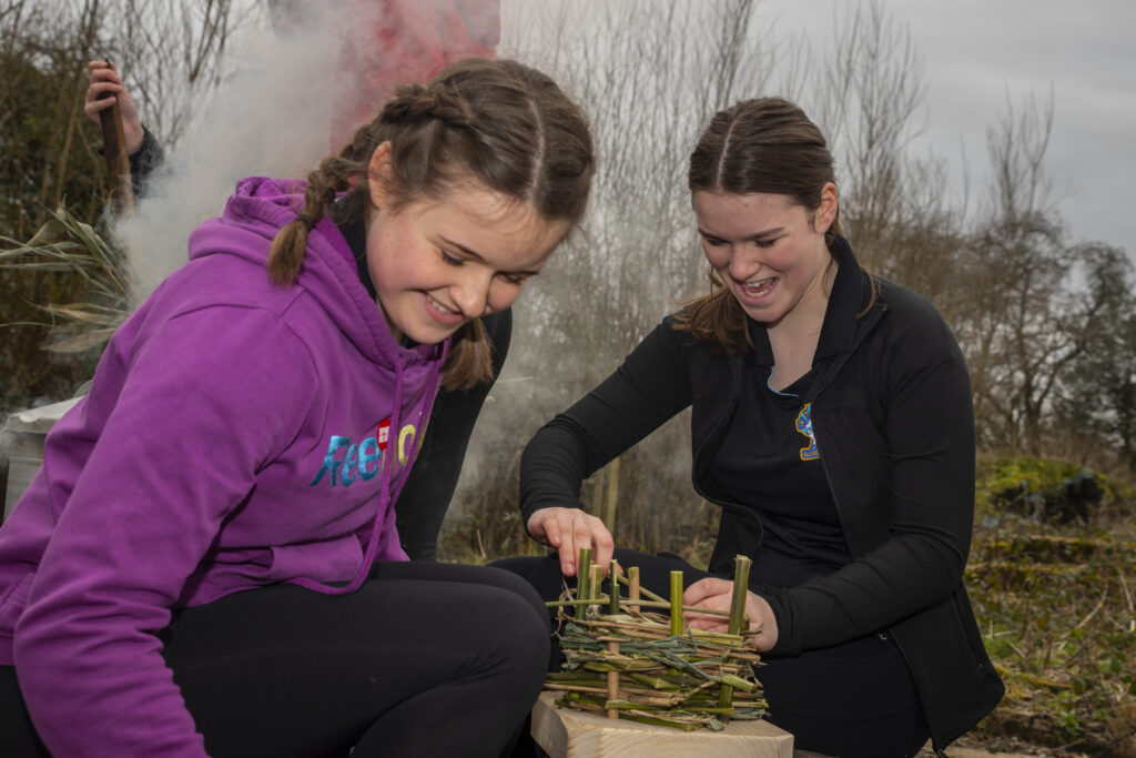 girls weaving a basket