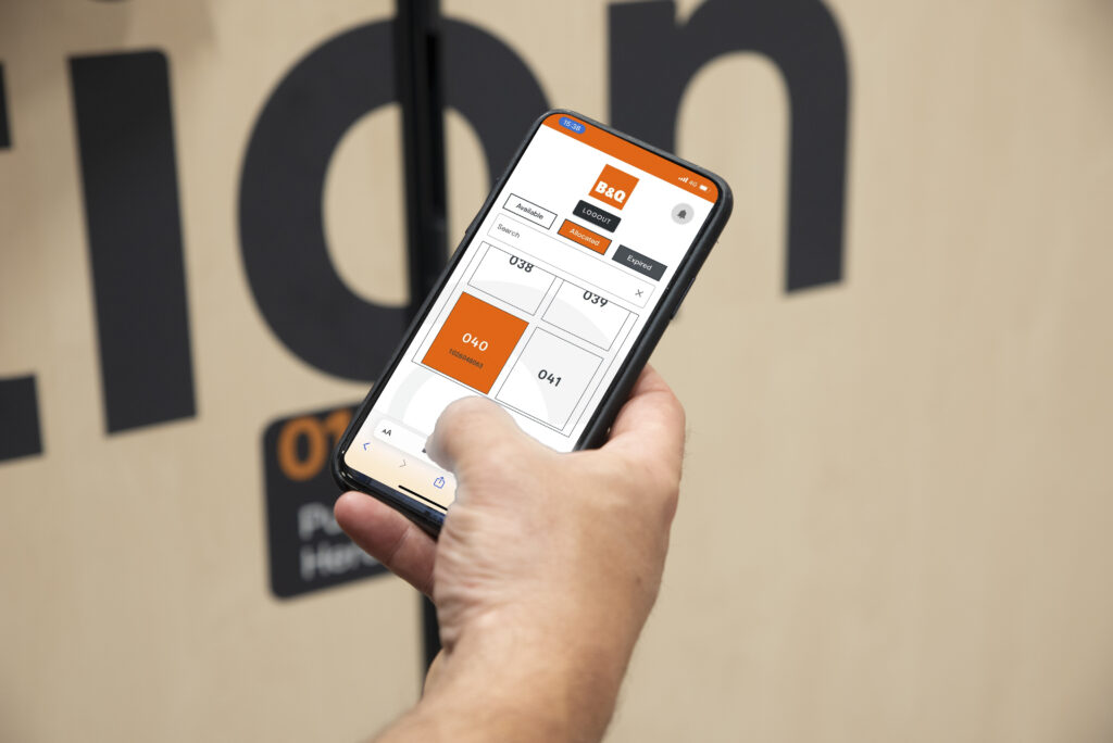 Young woman in b&q using a smart locker app